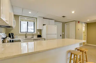 a kitchen with white cabinets and a counter top at All-Season Lake Wallenpaupack Condo with Views in Greentown