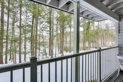 a balcony with a view of the snow covered trees at All-Season Lake Wallenpaupack Condo with Views in Greentown