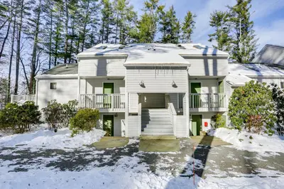 a white house with snow on the ground at All-Season Lake Wallenpaupack Condo with Views in Greentown