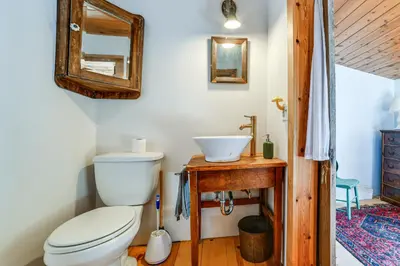 a bathroom with a toilet and a sink at Family Cabin Near Bellayre and Plattekill Mtns! in Andes