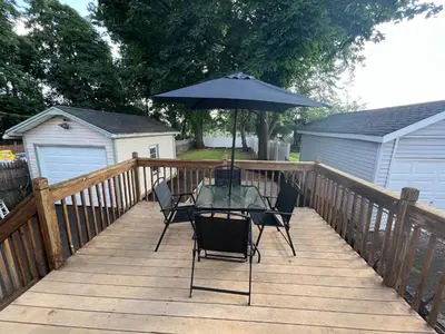a table with an umbrella on a wooden deck at Perfect full private first floor home with convenient amenities in Union