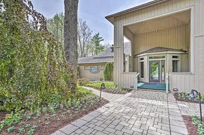 an exterior view of a house with a driveway at Lake Naomi Luxury Home with Stream Pool and Fire Pit in Pocono Pines