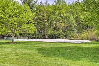 a grassy field with a soccer ball in it at Lake Naomi Luxury Home with Stream Pool and Fire Pit in Pocono Pines