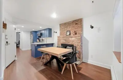 a kitchen and dining room with a table and chairs at New Cozy Must Have Stay! 10 minutes to NYC in Hoboken