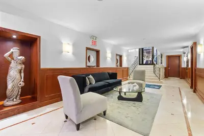 a living room with a couch and a table at Synergy Madison in New York