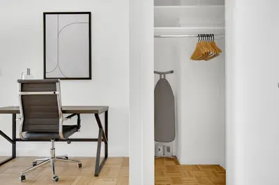 a desk and chair in a room with a mirror at Midtown 1BR w Gym Doorman nr Grand Central NYC-746 in New York