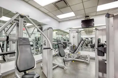 a gym with several treadmills and machines at Midtown 1BR w Gym Doorman nr Grand Central NYC-746 in New York