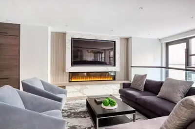 a living room with a couch and a fireplace at Midtown 1BR w Gym Doorman nr Grand Central NYC-746 in New York