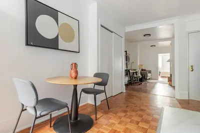 a dining room with a table and chairs in a room at Blueground Alphabet City washer nr Tompkins Square Park NYC-2161 in New York