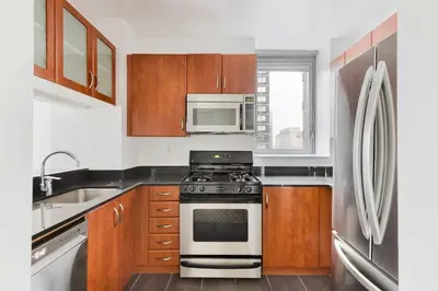 a kitchen with a stove and a microwave at Blueground Kips Bay rooftop nr NYC Skyline NYC-2158 in New York