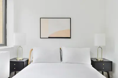 a bedroom with a white bed with two night stands at Blueground Kips Bay rooftop nr NYC Skyline NYC-2158 in New York