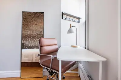 a bedroom with a desk and a chair and a bed at Blueground Nolita view nr Washington Square NYC-2051 in New York