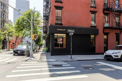 a street corner with a store on a city street at Blueground Nolita view nr Washington Square NYC-2051 in New York
