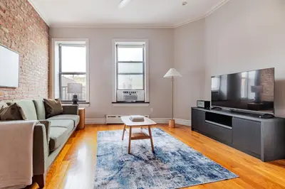 a living room with a couch and a tv at Blueground Nolita view nr Washington Square NYC-2051 in New York