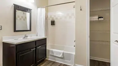 a bathroom with a sink and a tub and a shower at Landing Beautiful 2BD Pool Clubhouse in King of Prussia