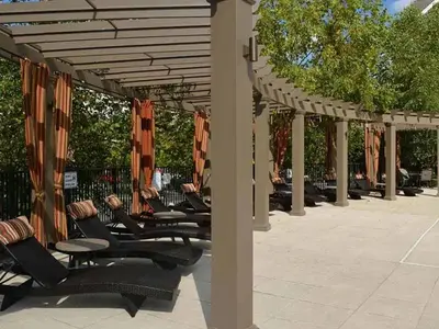 a row of black chairs under a pergola at Landing Beautiful 2BD Pool Clubhouse in King of Prussia