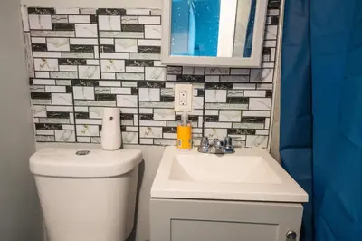 a bathroom with a toilet and a sink and a mirror at Casa Ebenecer - Habitación privada # 3 in Elizabeth
