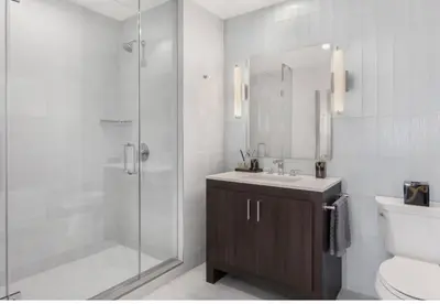 a bathroom with a shower and a sink and a toilet at Everlasting Reality in Fort Lee
