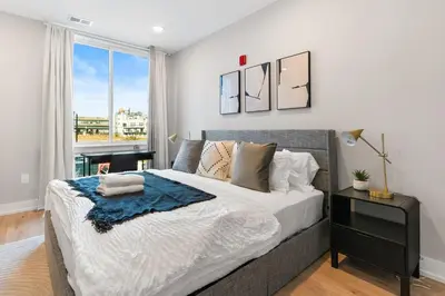 a bedroom with a large bed and a window at 1 bed APT - located next to center city in Philadelphia