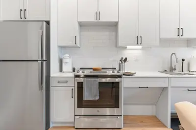 a white kitchen with a stove and a refrigerator at 1 bed APT - located next to center city in Philadelphia