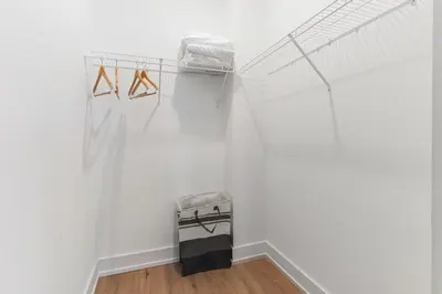 a room with white walls and a shelf with hangers at 1 bed APT - located next to center city in Philadelphia
