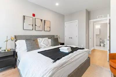 a bedroom with a large bed with white sheets at 1 bed APT - located next to center city in Philadelphia