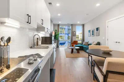 a kitchen and living room with a couch and a table at 1 bed APT - located next to center city in Philadelphia