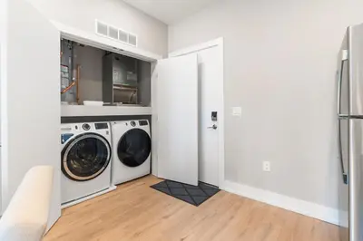 a white laundry room with a washer and dryer at 1 bed APT - located next to center city in Philadelphia