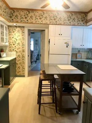 a kitchen with a table and a refrigerator at Holly Cottage Quaker Lake in Brackney