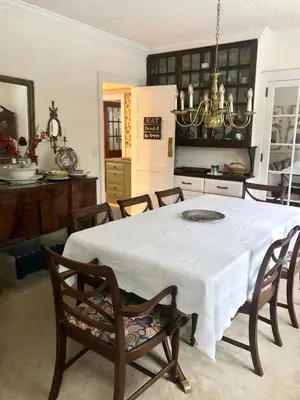 a dining room with a white table and chairs at Holly Cottage Quaker Lake in Brackney