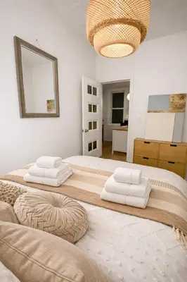 a bedroom with two beds with white towels on them at Cozy Little Italy Retreat Steps from SoHo in New York