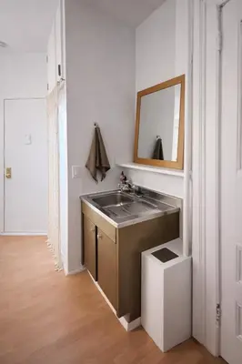 a bathroom with a sink and a mirror at Cozy Little Italy Retreat Steps from SoHo in New York