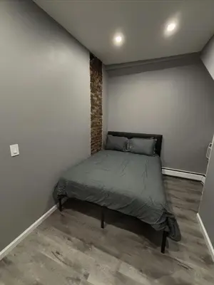 a small bedroom with a bed in the corner at The loft 2 bedroom apartment in Newark