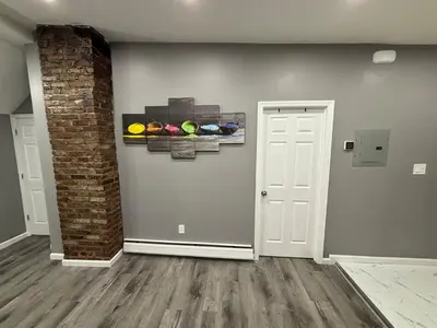 a room with a white door and paintings on the wall at The loft 2 bedroom apartment in Newark