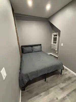 a bedroom with a bed in the corner of a room at The loft 2 bedroom apartment in Newark