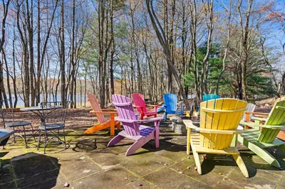 a group of colorful chairs sitting in a yard at Lakefront with Beach Game Room Fire-pit and More in Blakeslee