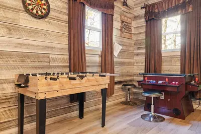 a ping pong table in a room with a pool table at Lakefront with Beach Game Room Fire-pit and More in Blakeslee