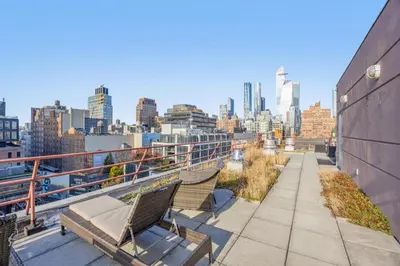 a balcony with two benches and a view of the city at Chelsea 1BR in Shared Apt with Laundry and Rooftop in New York