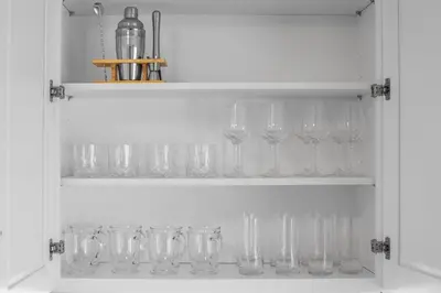 a row of wine glasses sitting on a shelf at Charming Entire Home,18m to Manhattan, Home Theater in Carlstadt
