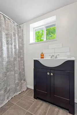 a bathroom with a sink and a shower curtain at Country Chic 3BR Retreat Near All Star Village in Treadwell