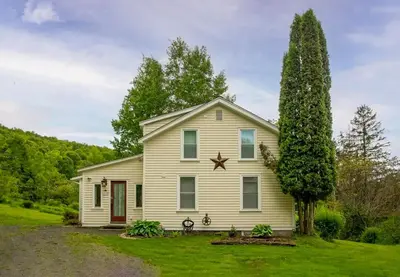 a white house with a star on the roof at Country Chic 3BR Retreat Near All Star Village in Treadwell