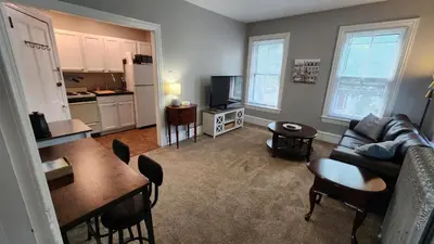 a living room with a couch and a table at Waterfront Getaway in Historic Bristol in Bristol
