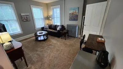 a living room with a couch and a table at Waterfront Getaway in Historic Bristol in Bristol