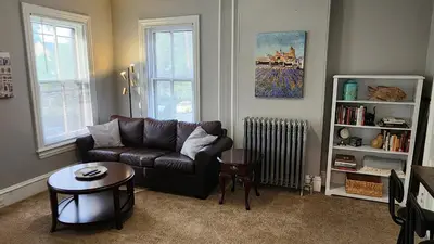 a living room with a couch and a table at Waterfront Getaway in Historic Bristol in Bristol