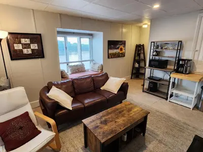 a living room with a couch and a coffee table at Waterfront Getaway in Historic Bristol in Bristol