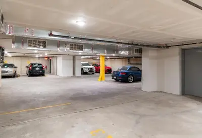 a parking garage with several cars parked in it at 1BR1BA apartment in the Fairmount Square building in Philadelphia