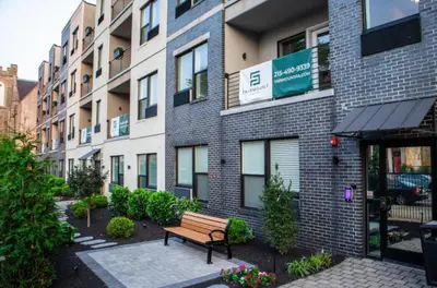 a bench sitting in front of a building at 1BR1BA apartment in the Fairmount Square building in Philadelphia