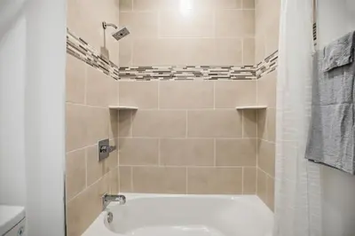 a bathroom with a white tub and a sink at 1BR1BA apartment in the Fairmount Square building in Philadelphia