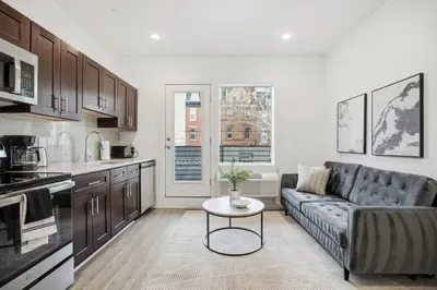 a living room with a couch and a table at 1BR1BA apartment in the Fairmount Square building in Philadelphia