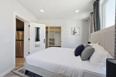 a bedroom with a large white bed with pillows at Modern 2BR, 1BA Apartment in Great Location in Philadelphia
